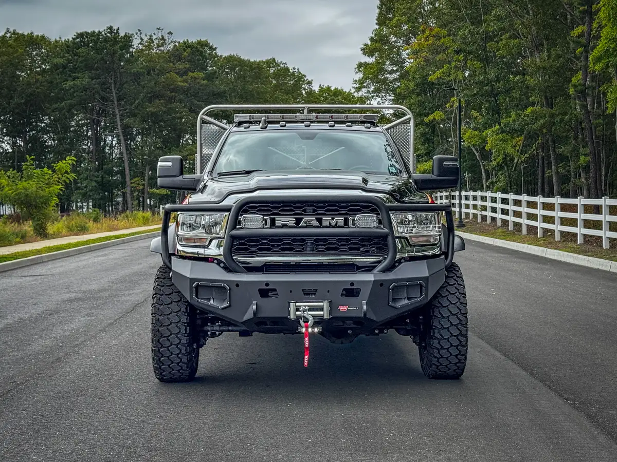 Head-on front exterior view showing grille guard, bumper winch opening, and front tires.